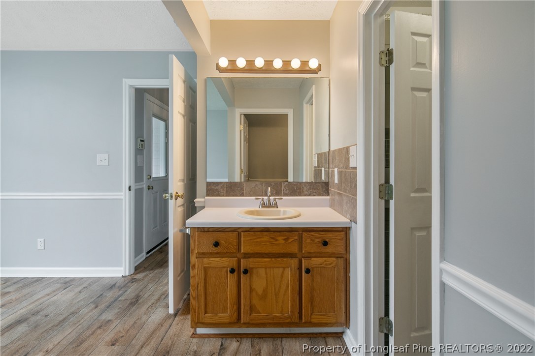 203 Cobblestone Court Raeford, NC 28376 - Photo 27 of 46 a bathroom with a granite countertop sink a mirror and a shower