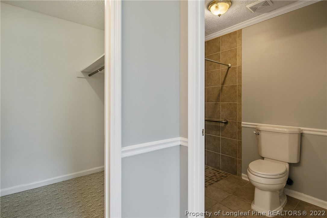 203 Cobblestone Court Raeford, NC 28376 - Photo 28 of 46 a bathroom with a toilet and a shower