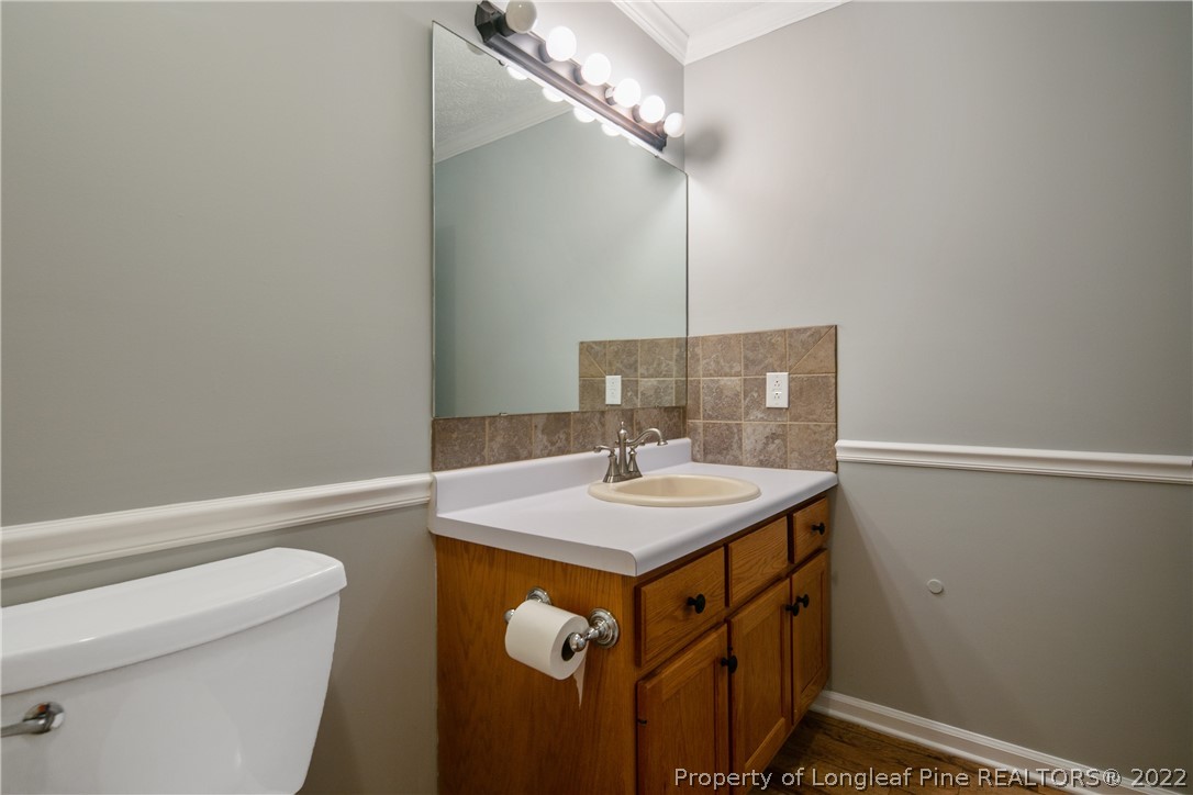 203 Cobblestone Court Raeford, NC 28376 - Photo 37 of 46 a bathroom with a sink a toilet and a mirror