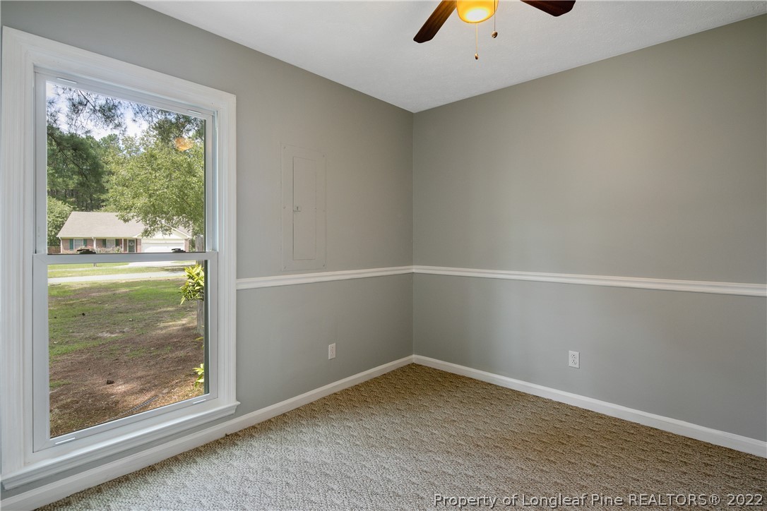 203 Cobblestone Court Raeford, NC 28376 - Photo 39 of 46 an empty room with wooden floor and windows