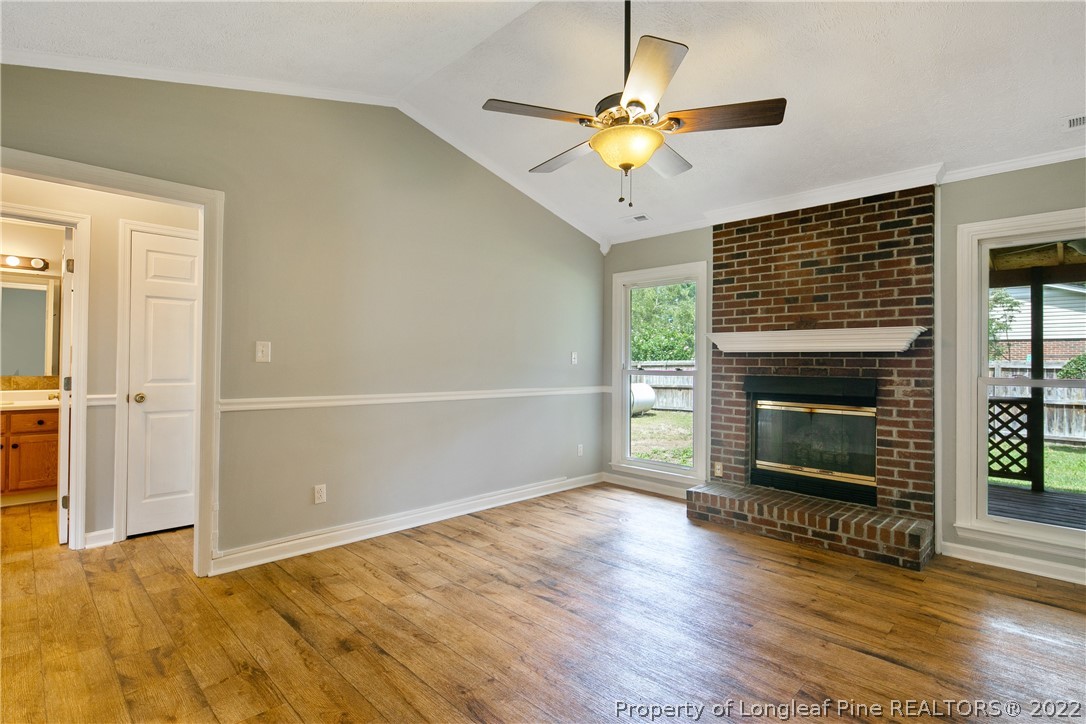 203 Cobblestone Court Raeford, NC 28376 - Photo 7 of 46 a view of an empty room with wooden floor fireplace and a window