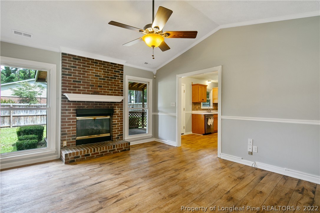 203 Cobblestone Court Raeford, NC 28376 - Photo 8 of 46 a view of an empty room with a fireplace and a window