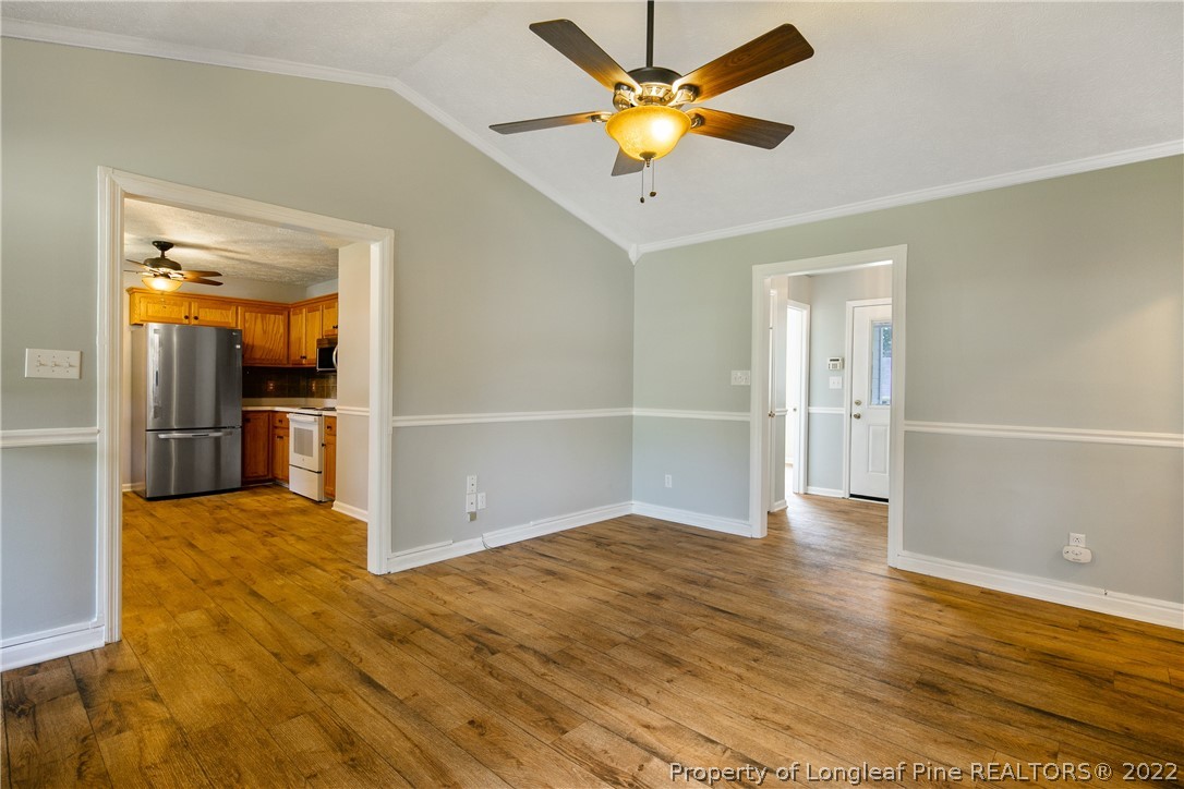 203 Cobblestone Court Raeford, NC 28376 - Photo 9 of 46 wooden floor in an empty room with a kitchen
