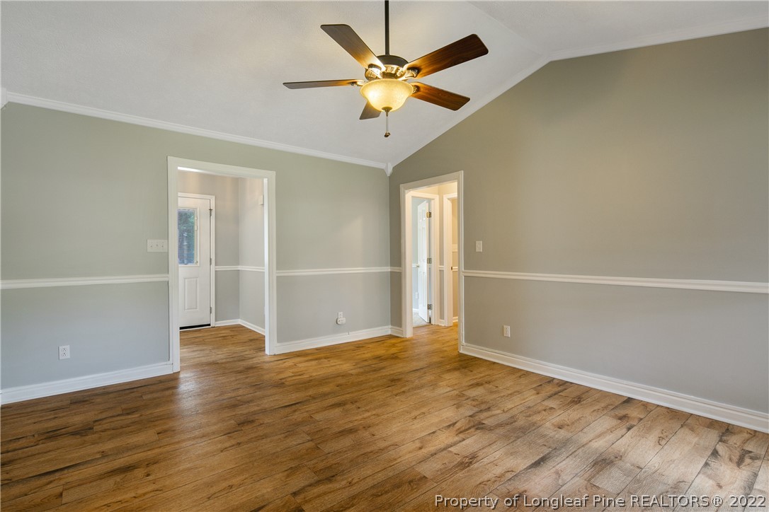 203 Cobblestone Court Raeford, NC 28376 - Photo 10 of 46 an empty room with wooden floor and ceiling fan