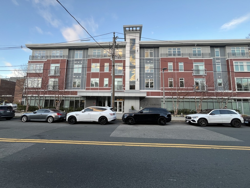 a view of a street that has couple of cars parked on the road