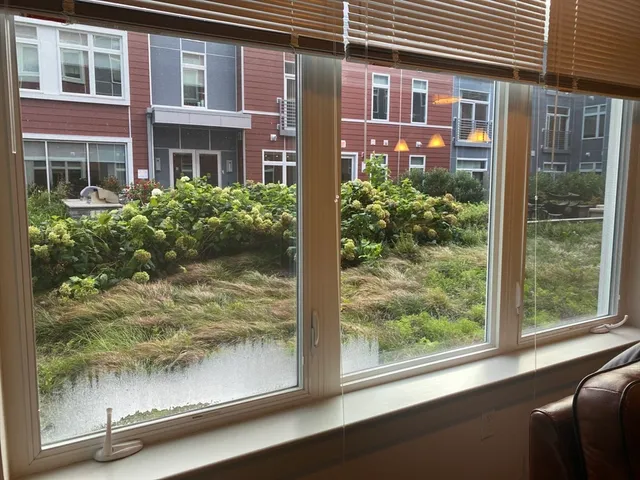 a view of a brick house with a large window