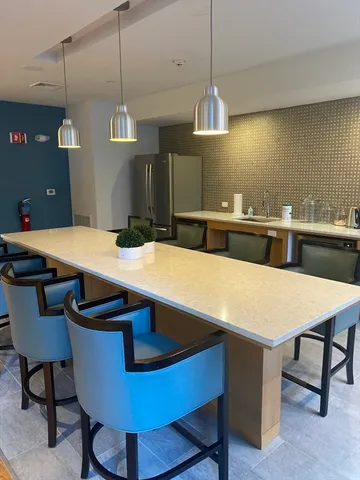 a kitchen with a table and chairs in it