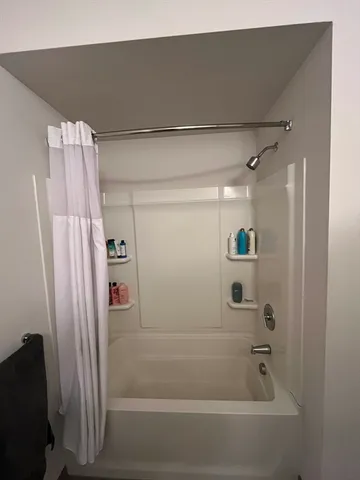 a bed sitting in a room next to a window