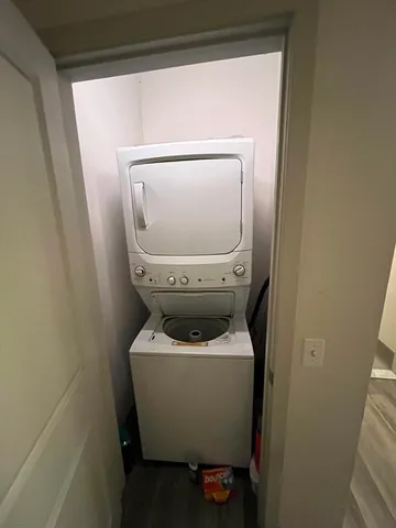 a living room with furniture a wooden floor and a book shelf