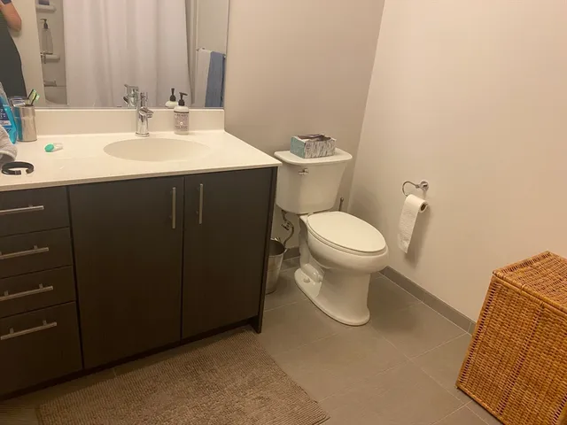 a bathroom with a sink toilet and a mirror