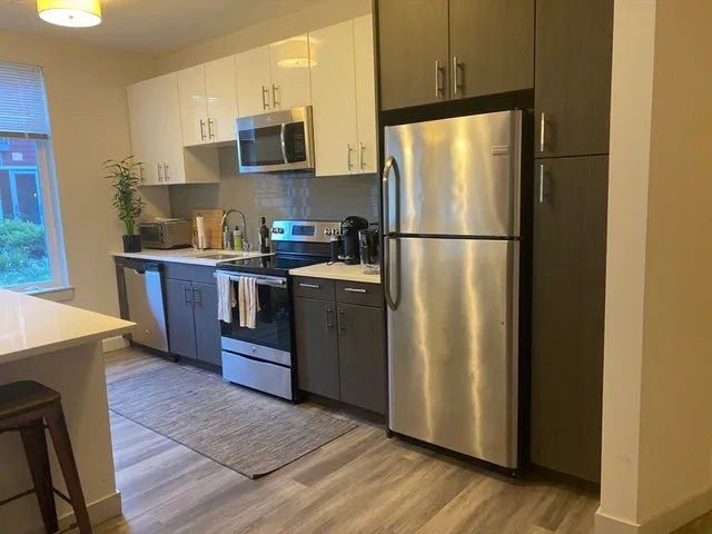 a kitchen with stainless steel appliances a refrigerator sink and microwave
