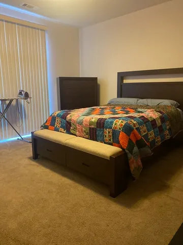 a bedroom with a bed and a window