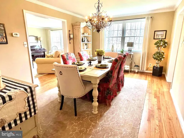 a view of a dining room with furniture and a chandelier