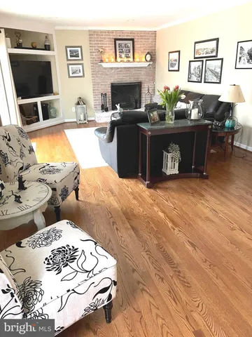 a living room with fireplace furniture and a flat screen tv
