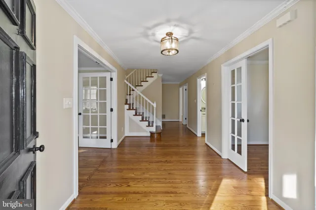a view of an entryway with wooden floor and stair