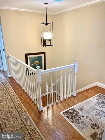 a view of a hallway with wooden floor and a floor to ceiling window