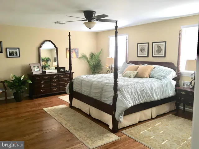 a bedroom with a bed and a potted plant