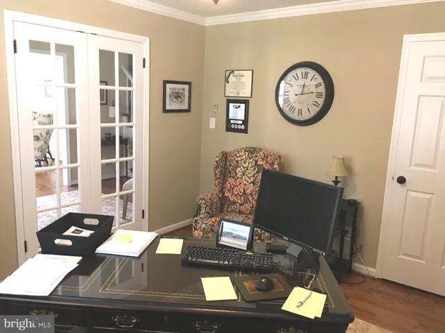 a view of a workspace with furniture and a window