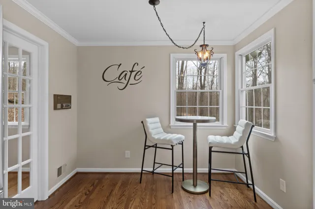a view of a livingroom with furniture wooden floor and windows