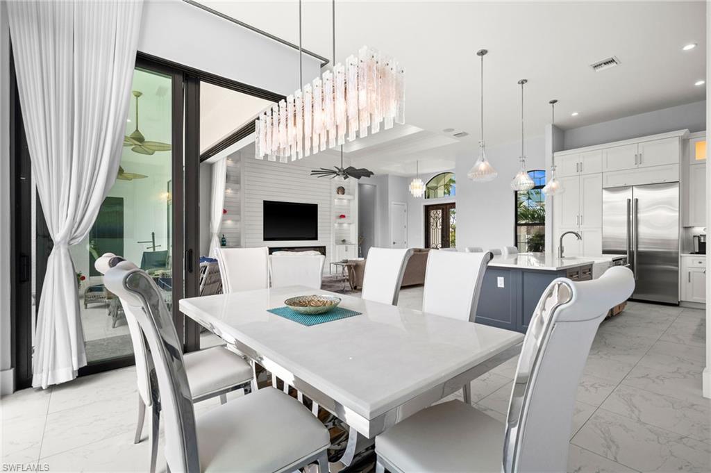 388 Pine Avenue Naples, FL 34108 - Photo 18 of 34 a view of a dining room with furniture window and wooden floor