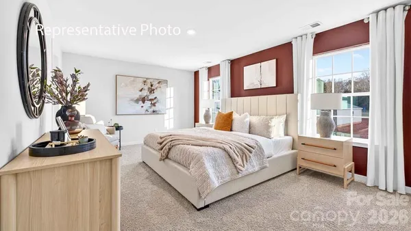 a bedroom with a bed a dresser and next to a window