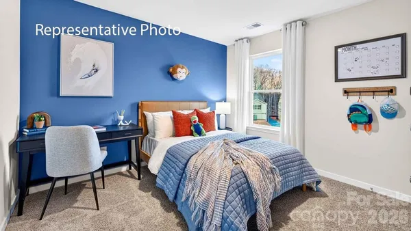 a bedroom with a bed and a desk