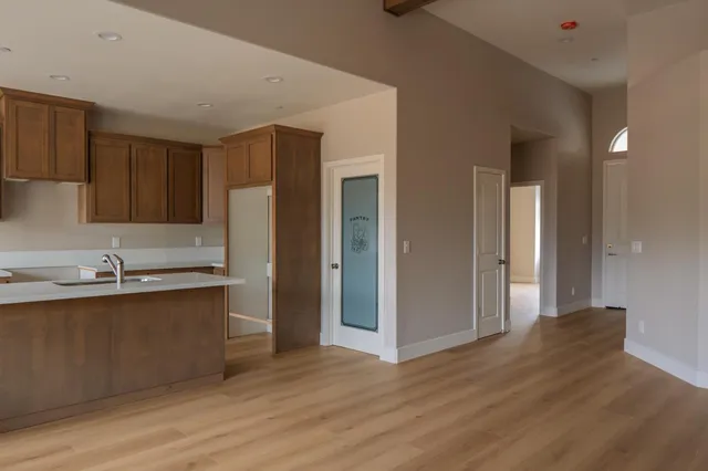 a kitchen with stainless steel appliances granite countertop a refrigerator and a sink