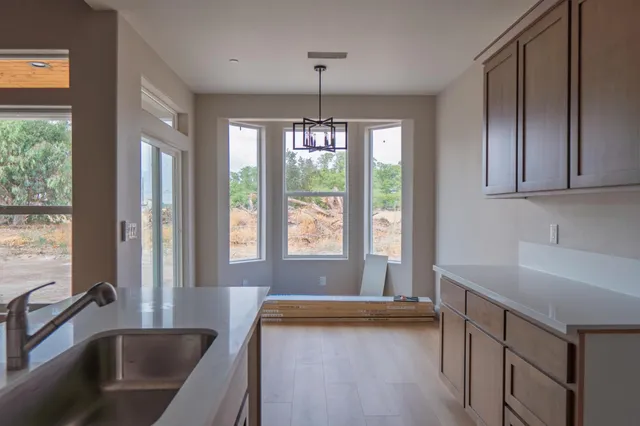 a view of a kitchen with a tub and window