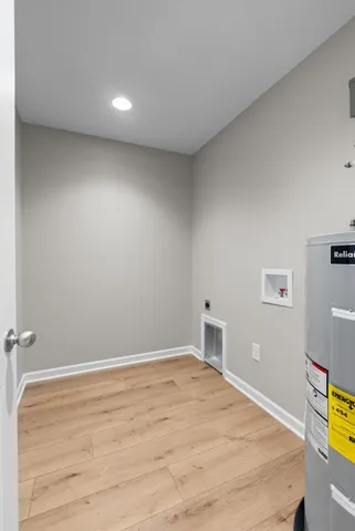 a room with a bed and painting on the wall