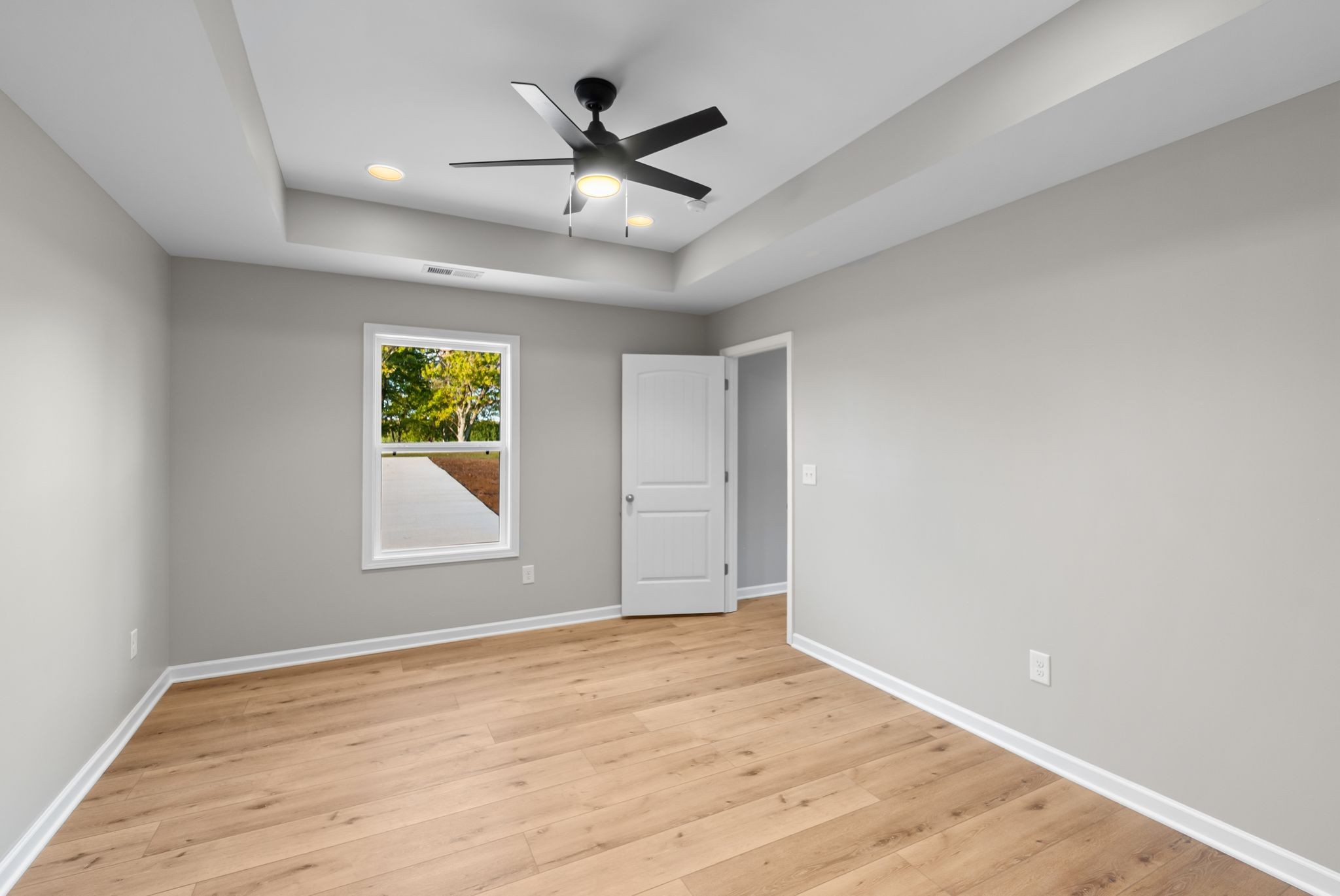 81 Dukes Park Road Summertown, TN 38483 - Photo 23 of 32 an empty room with wooden floor and windows