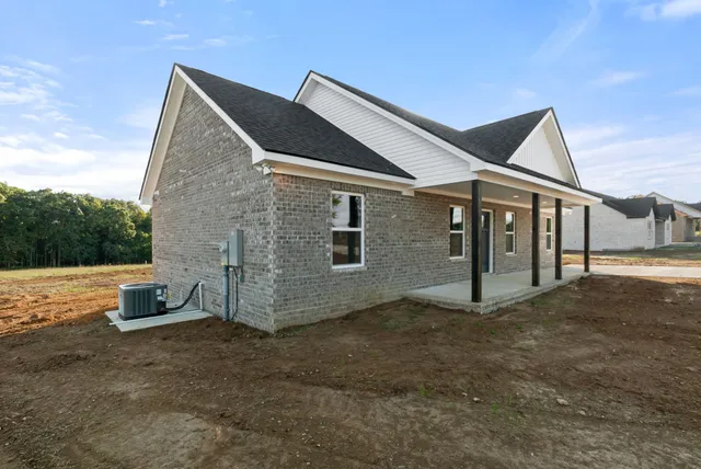 a backyard of a house with table and chairs