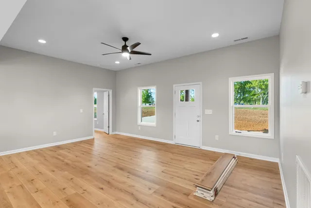 an empty room with windows and closet
