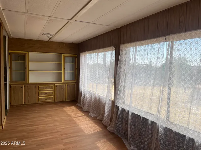 a hallway with cabinets and wooden floor