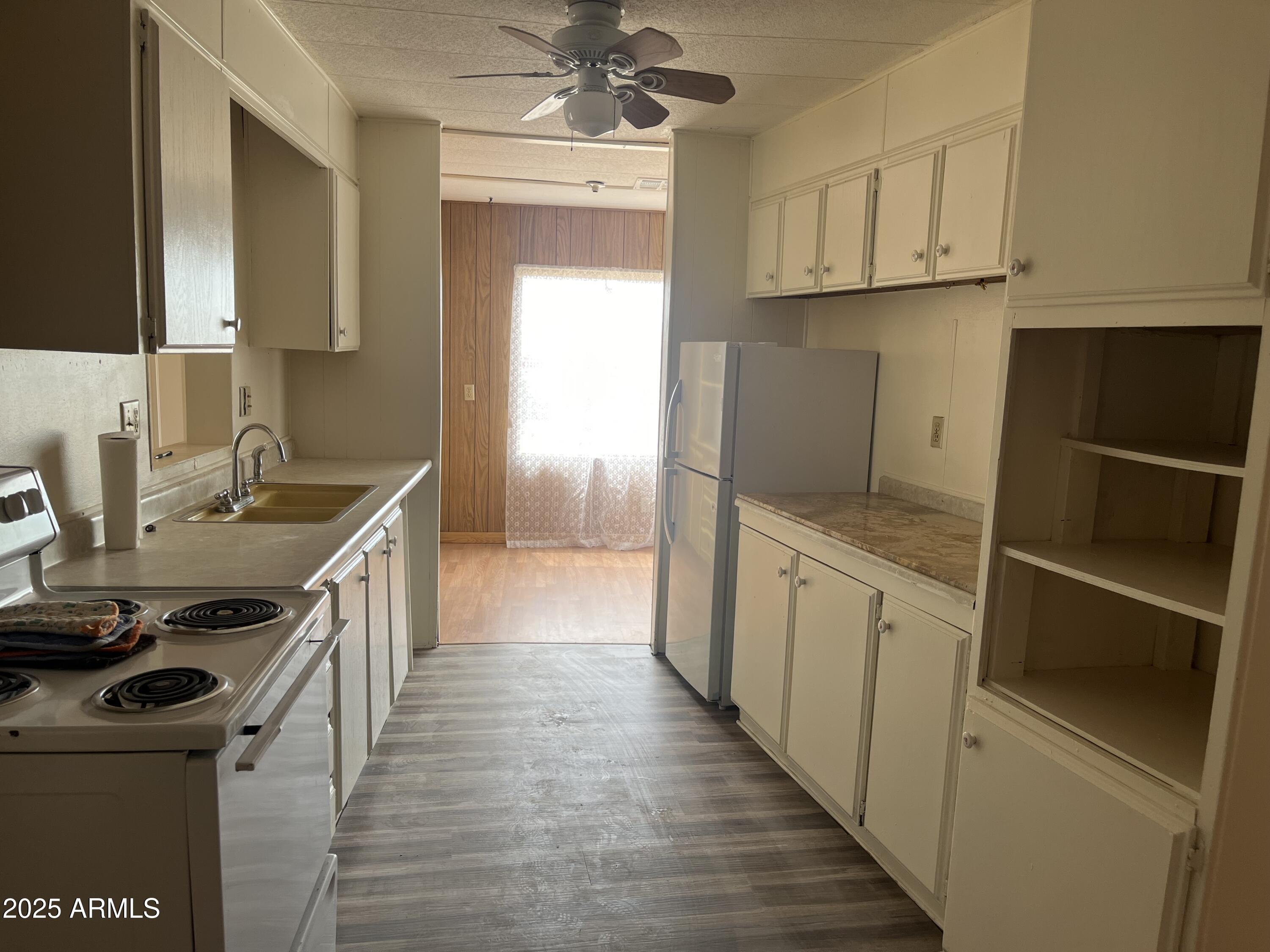 22695 East Cactus Forest Road Florence, AZ 85132 - Photo 10 of 45 a kitchen with a sink stove and cabinets