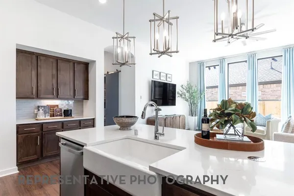 a view of a dining room with furniture a chandelier and wooden floor