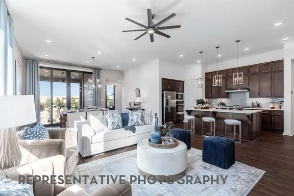 a living room with kitchen and furniture