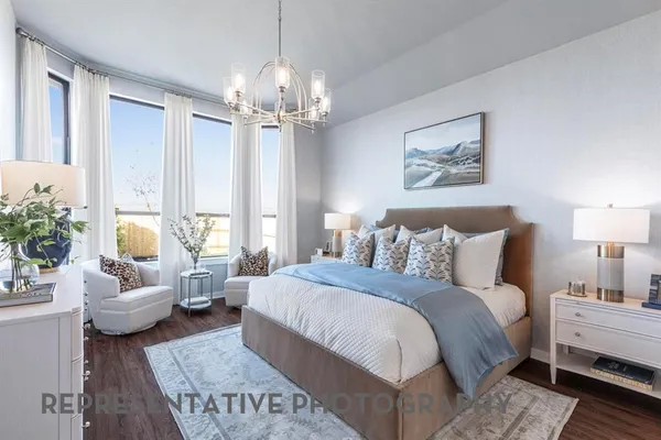 a spacious bedroom with bed and a couch