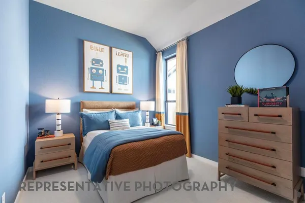 a bedroom with a bed and a painting on the wall