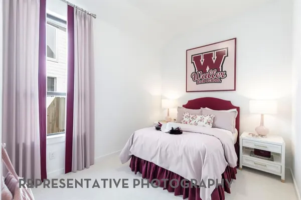 a bedroom with a balcony a bed and a window