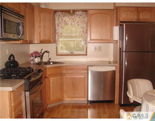 423 Monmouth Road Jackson, NJ 08527 - Photo 4 of 10 a kitchen with stainless steel appliances granite countertop a refrigerator stove and sink