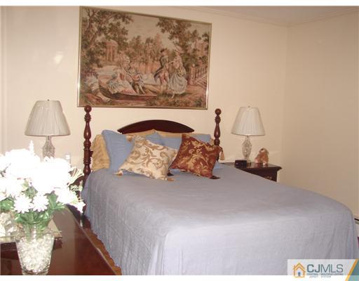 423 Monmouth Road Jackson, NJ 08527 - Photo 5 of 10 a bedroom with a bed and a painting on the wall