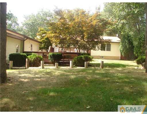 423 Monmouth Road Jackson, NJ 08527 - Photo 7 of 10 a view of a backyard with table and chairs and potted plants