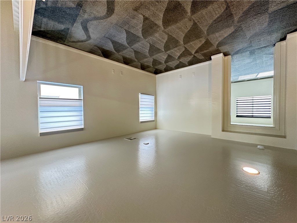6784 Pivot Point Street Las Vegas, NV 89148 - Photo 12 of 27 A well-lit, versatile space features a unique textured ceiling and clean, neutral flooring.