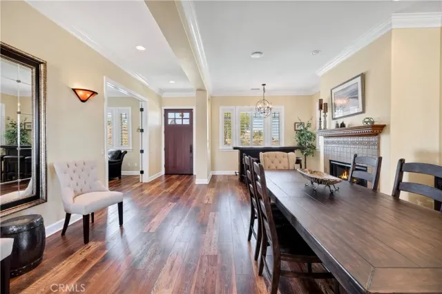 a view of a a dining room with furniture window and wooden floor