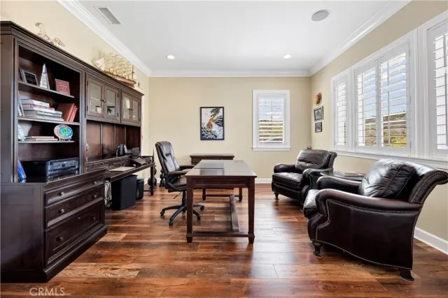 a view of a dining room with furniture and wooden floor