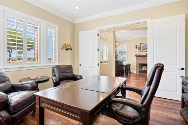 a very nice looking living room with a large window and wooden floor