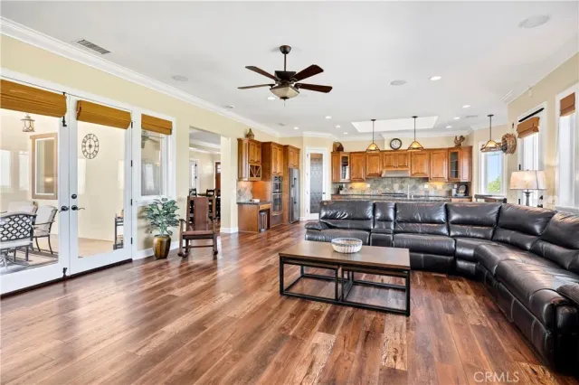 a living room with furniture a flat screen tv and wooden floor