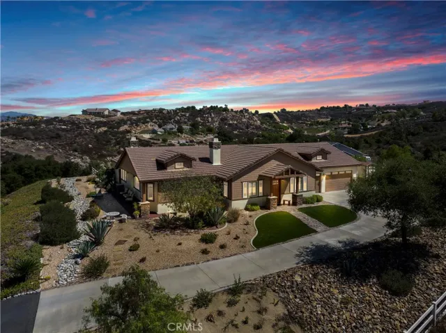 a kitchen with stainless steel appliances granite countertop a sink a stove and a wooden floors