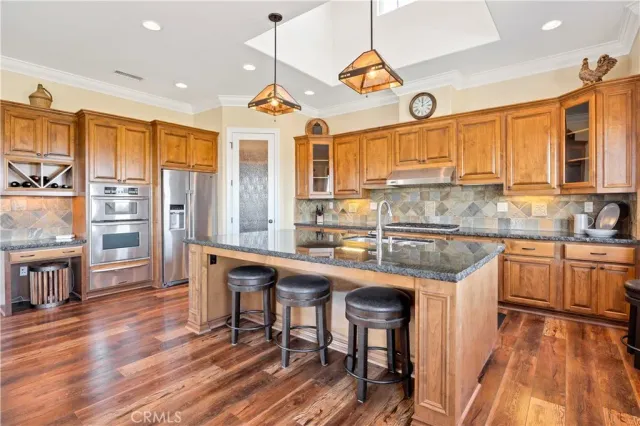 a kitchen filled counter top space a sink a stove and a window