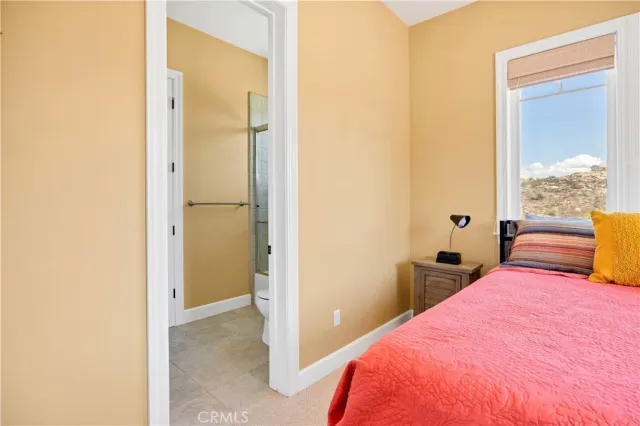 a view of a terrace with chairs and a umbrella